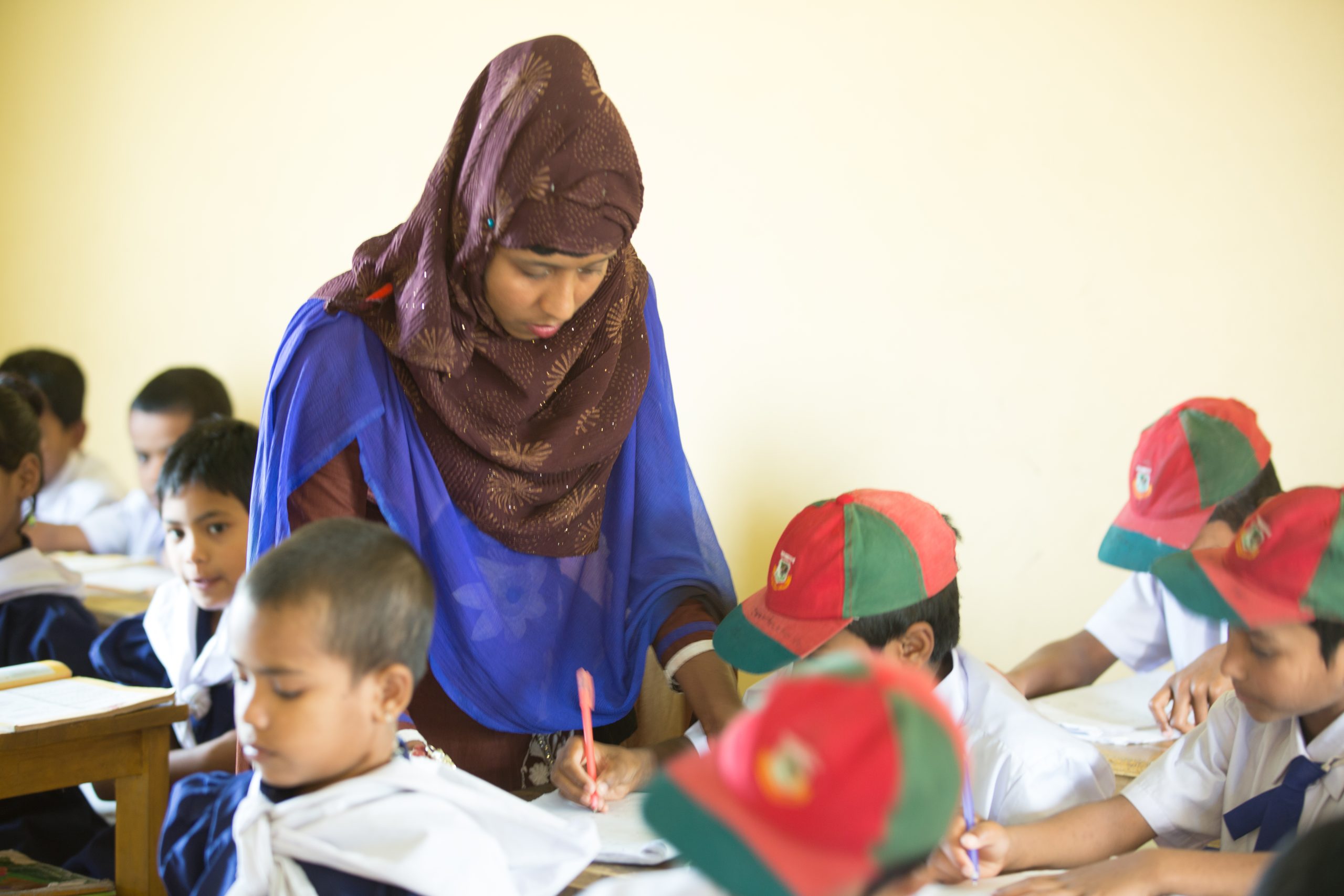 A Hope and Prosperity teacher supporting children in the classroom