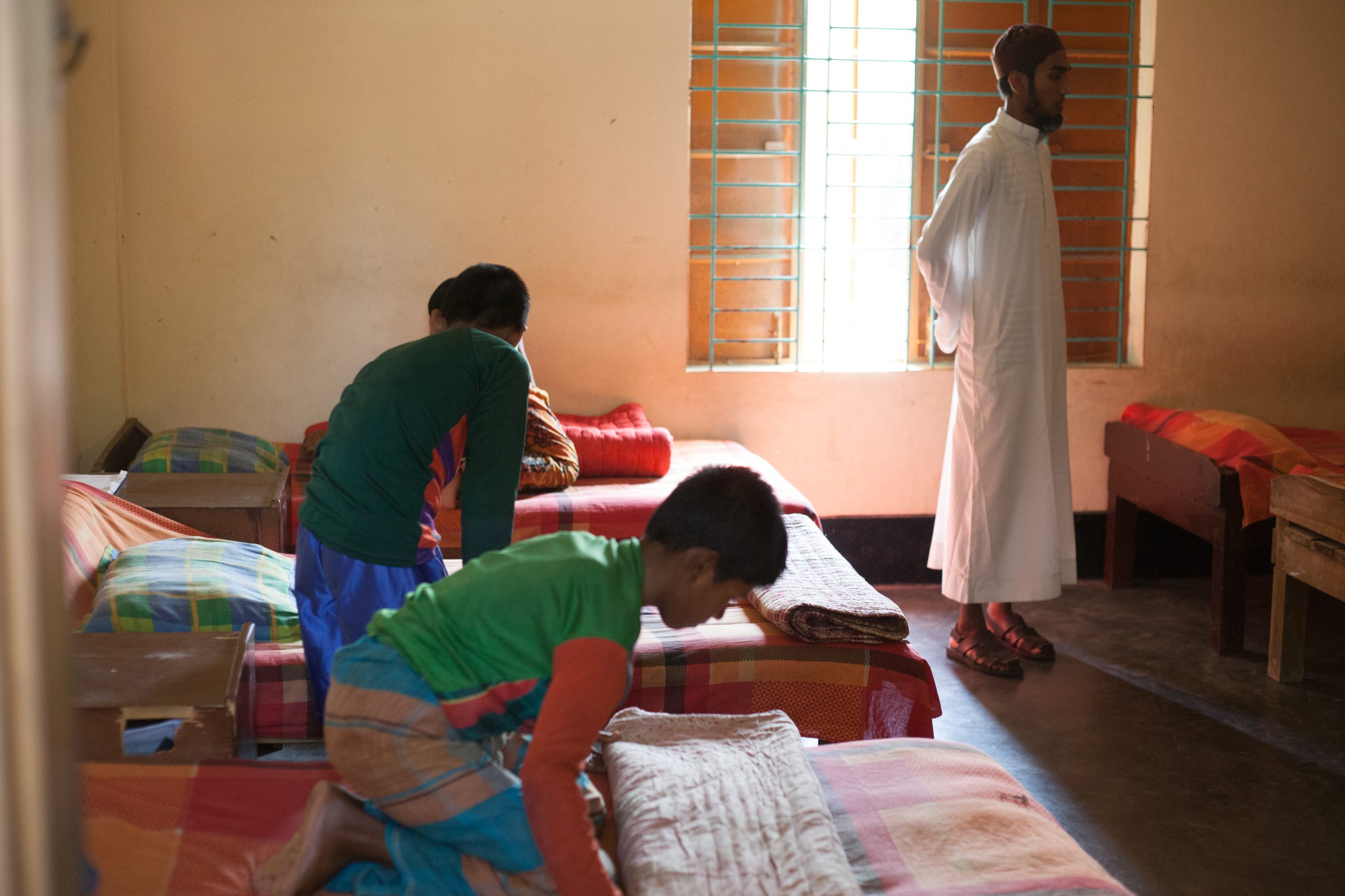 Children arranging their beds in a Hope and Prosperity bedroom