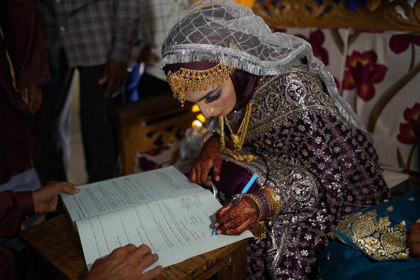 Wedding documents being signed during the celebration