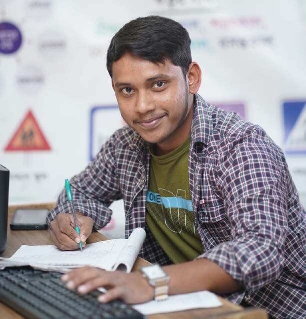 Zakir Hussain studying at a desk